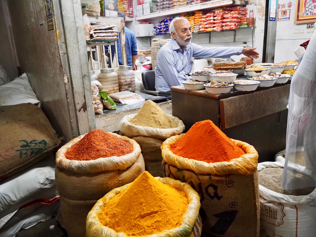 Vendor selling colourful fabrics and trims in Mandvi market