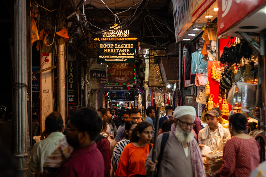 Crowded street market with textile shops and shoppers in Mandvi